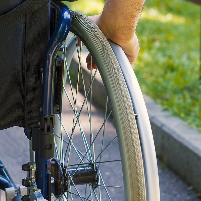 wheel chair user in the gardens at Roxburghe House Aberdeen