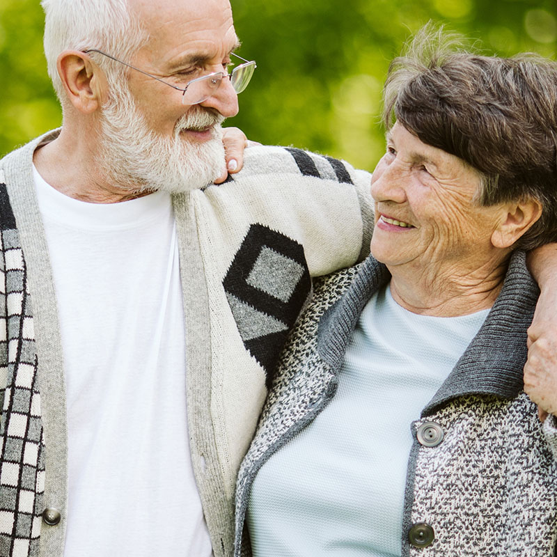 An elderly couple walking in the gardens at Roxburghe House Aberdeen