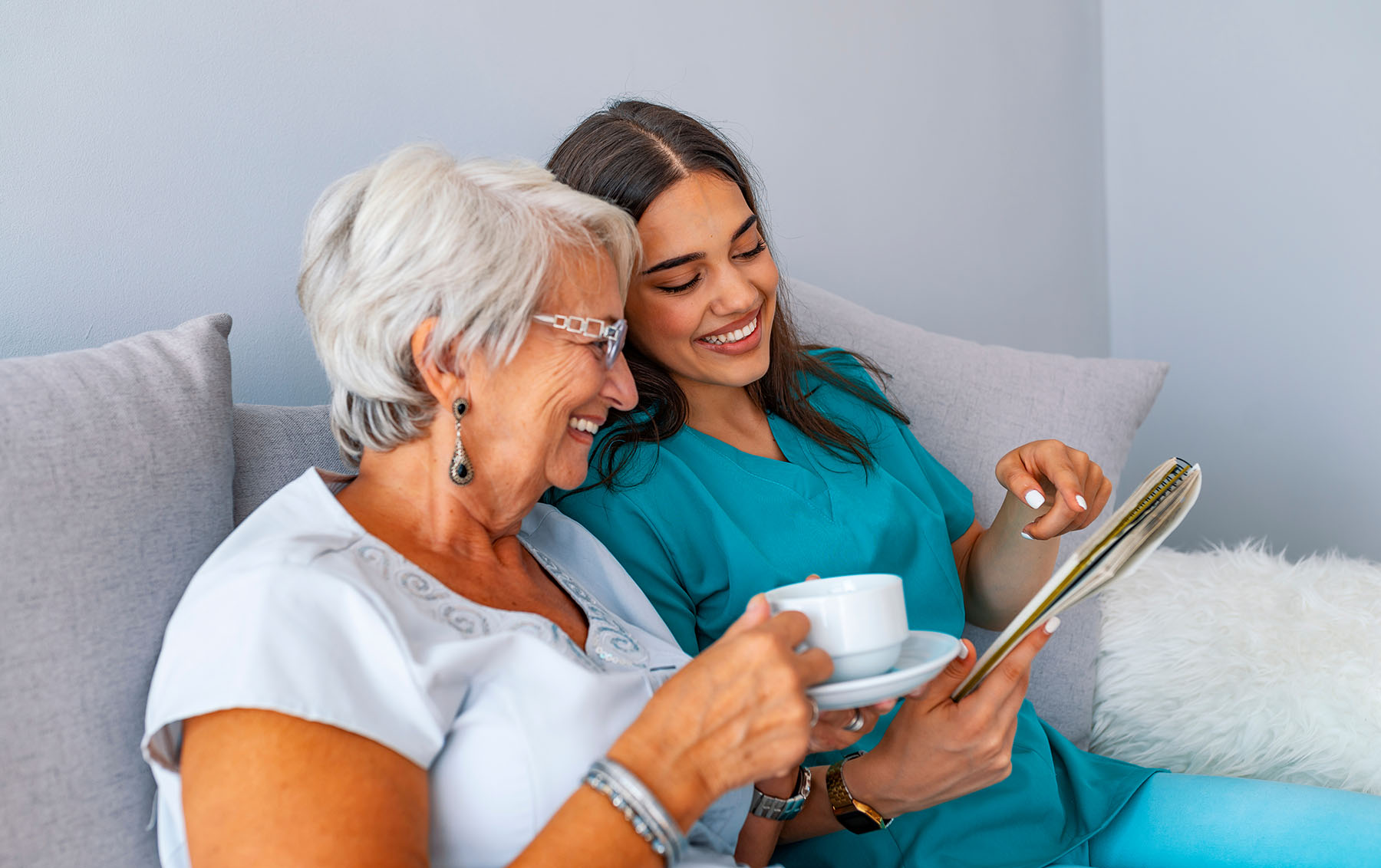 Nurse and patient enjoying a cup of tea and a chuckle